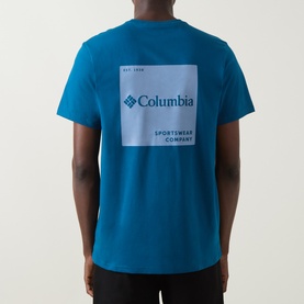 Model wearing Columbia CSC Logo Back Graphic T-Shirt in Phoenix Blue, showing back graphic logo print, round neck, short sleeves