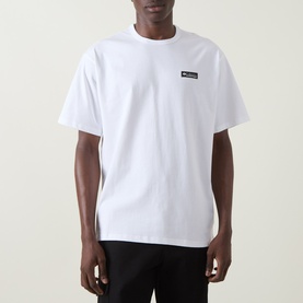 Model wearing Columbia white crew neck T-shirt with small branded chest patch, short sleeves, relaxed fit, in 100% cotton