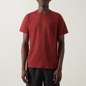 Model wearing Columbia Red Oxide cotton T-shirt with chest pocket and crew neck, paired with dark trousers.