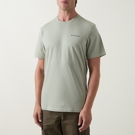 Model wearing Columbia CSC Outdoor Back Graphic T-Shirt in Safari green, round neck, short sleeves, paired with khaki trousers