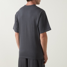 Model wearing Columbia CSC Retro Logo T-Shirt in Shark grey, rear view, relaxed fit, short sleeves, straight hemline, styled with matching trousers.