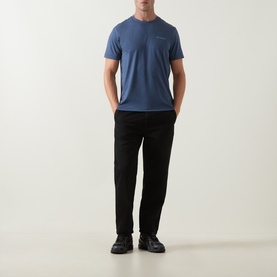 Model wearing Columbia Parons Logo Back Graphic T-Shirt in Collegiate Navy, styled with black trousers and black shoes.