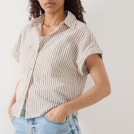 Model wearing Marc O Polo light beige stripe cotton blouse with short sleeves and chest pockets, styled with light blue jeans