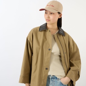 Model with Marc O Polo Script Logo Cap in Sandpaper, curved visor with embroidered script logo, styled with camel oversized jacket and jeans
