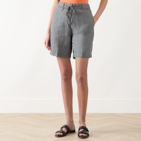 Model wearing Marc O Polo Woven Linen Shorts in Slate Grey Melange, mid-rise straight-leg cut with drawstring waist, styled with black flat sandals