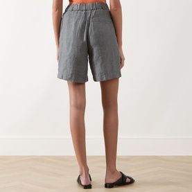 Model wearing Marc O Polo Woven Linen Shorts in Slate Grey Melange, mid-rise straight-leg style with elasticated waistband, styled with black flat