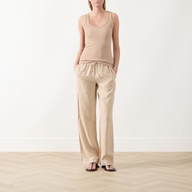 Model wearing Marc O Polo Linen Straight-Leg Trousers in Sandpaper with elasticated drawstring waist, styled with a matching ribbed tank top