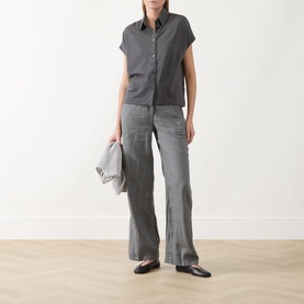 Model wearing Marc O Polo Linen Straight-Leg Trousers in Slate Grey Melange, styled with a matching grey short-sleeve shirt and black flat shoes.