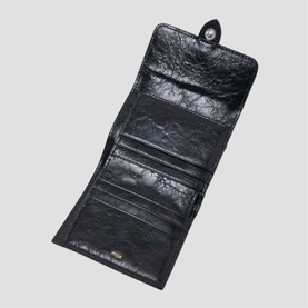 Maje black leather bi-fold wallet open, showing multiple card slots and snap button closure
