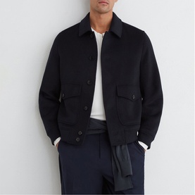 Model wearing Reiss blue wool-blend bomber jacket with patch pockets, styled with white tee and navy trousers