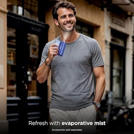 Model with Shark ChillPill 3-in-1 Fan Mist and InstaChill System Haze in blue, held outdoors, styled with grey t-shirt