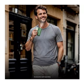 Model holding Shark ChillPill 3-in-1 Fan Mist and InstaChill System in Matcha green, wearing grey t-shirt, outdoors