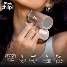 Shark ChillPill 3-in-1 Fan Mist and InstaChill System in Iced Latte, held to neck, rose gold compact handheld device with mesh cooling head