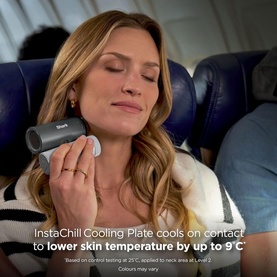 Model with Shark ChillPill 3-in-1 Fan Mist and InstaChill System held to neck, reclining in aircraft seat