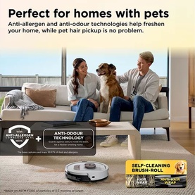 Lifestyle shot of a robot vacuum on a light wood floor, couple with a dog on a sofa, highlighting pet hair pickup and anti-allergen features