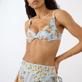 Model wearing Agua Bendita Hacienda Valle Bikini Top in multicolour floral print, underwired sweetheart neckline, wide straps, styled with matching