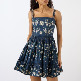 Model wearing Agua Bendita Lima Promesa Mini Dress in multicolour floral print with square neckline, embroidered straps and tiered A-line skirt