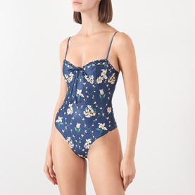 Model wearing Agua Bendita multicolour floral swimsuit with sweetheart neckline, ruched bust, and thin adjustable straps.