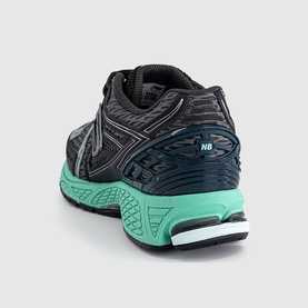 New Balance trainer in Black Metallic Deep End, rear view showing mint green cushioned sole, mesh upper and NB heel tab detail