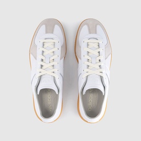 Adidas trainers in FTWR White, overhead view showing lace-up front, grey suede panels, and tan gum sole.