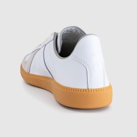 Adidas trainer in white leather, rear three-quarter view, with tonal stitching detail and tan gum rubber sole.