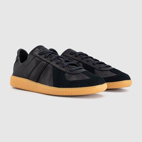 Adidas trainers in core black with three-stripe detail, suede and nylon upper, and contrasting gum rubber sole.