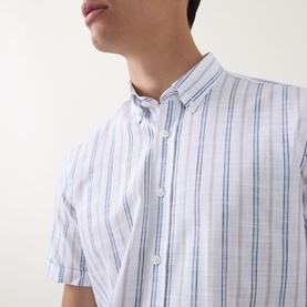 Model wearing Bugatti Stripe Slub Shirt in blue beige, short-sleeve cotton shirt with button-down collar and vertical stripe pattern.