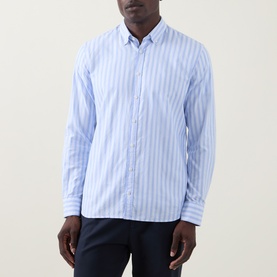 Model wearing Bugatti Soft Oxford Shirt in blue stripe, button-down collar, chest pocket, paired with navy trousers.