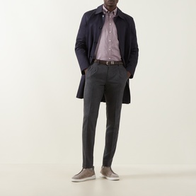 Model wearing Bugatti Soft Oxford Shirt in Blackberry with navy overcoat, grey trousers and taupe slip-on shoes.