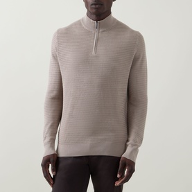 Model wearing Bugatti beige cotton half zip knit, featuring textured ribbed pattern and contrast zip detail.