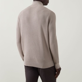 Model wearing Bugatti beige cotton half zip knitwear, back view showing ribbed texture detail, styled with dark trousers