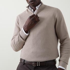 Model wearing Bugatti beige cotton half zip knit, styled with a white shirt and dark trousers with brown belt