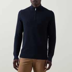 Model wearing Bugatti navy cotton half-zip knit jumper, styled with tan trousers. Textured stitch detail, silver zip.