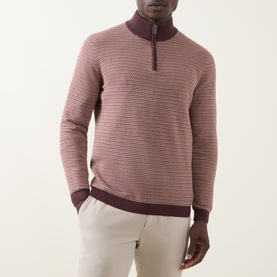 Model wearing Bugatti Textured Half-Zip Sweater in Blackberry with contrasting ribbed trims and funnel neck, styled with cream trousers.