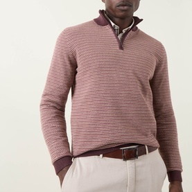 Model wearing Bugatti Textured Half-Zip Sweater in Blackberry with contrasting ribbed trims, styled with a shirt collar and beige trousers.