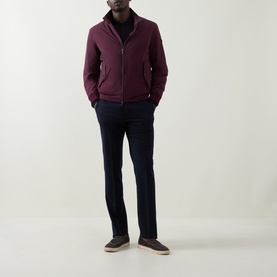 Model wearing Bugatti Black Berry zip-up outerwear jacket, styled with navy trousers and grey shoes.