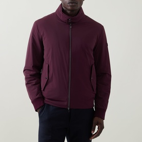 Model wearing Bugatti Black Berry zip-up outerwear jacket with funnel neck, styled with navy trousers.