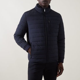 Model wearing Bugatti Zip Pocket Padded Jacket in navy with funnel neck, quilted front, chest zip pocket and ribbed cuffs.