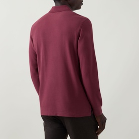 Model wearing Bugatti blackberry long-sleeve polo shirt, shown from behind, paired with dark trousers.