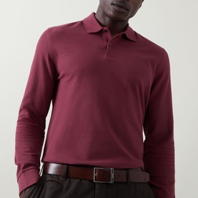 Model wearing Bugatti blackberry long-sleeve cotton polo shirt, styled with a dark leather belt.