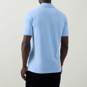Model wearing Bugatti light blue polo shirt, rear view, short sleeves, worn with black trousers
