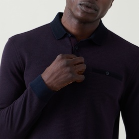 Model wearing Bugatti blackberry long-sleeve polo sweat with contrast navy collar, cuffs, and chest pocket detail.