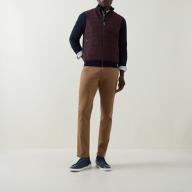 Model wearing Bugatti blackberry quilted front zip sweat with navy sleeves, styled with tan chinos and navy trainers.