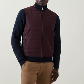 Model wearing Bugatti blackberry quilted front zip-through sweat with navy knit sleeves, styled with tan trousers