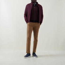Model wearing Bugatti Blackberry sweatshirt, styled with burgundy zip jacket, tan chinos and navy trainers.