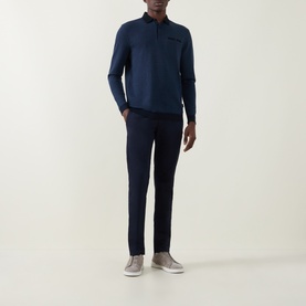 Model wearing Bugatti Lux Slim-Leg Chinos in navy, styled with a matching navy long-sleeve polo and grey trainers.