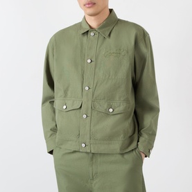 Model wearing Emporium 89 Ripstop Logo Jacket in green with point collar, front button fastening and flap pockets, styled with matching green