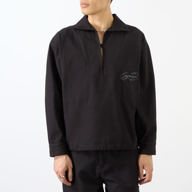 Model wearing Emporium Logo Pullover Polo Shirt in black, cropped fit with half-zip, polo collar, and tonal logo embroidery on chest.