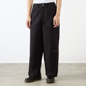 Model wearing Emporium Ripstop Fatigue Wide Leg Denim Trousers in black, wide-leg silhouette with embroidered logo detail, styled with black shoes.