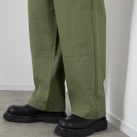 Model wearing Emporium Ripstop Fatigue Wide Leg Denim Trousers in green, wide-leg silhouette, styled with black chunky boots.